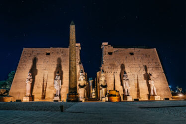 illuminated entrance of the Luxor Temple at night