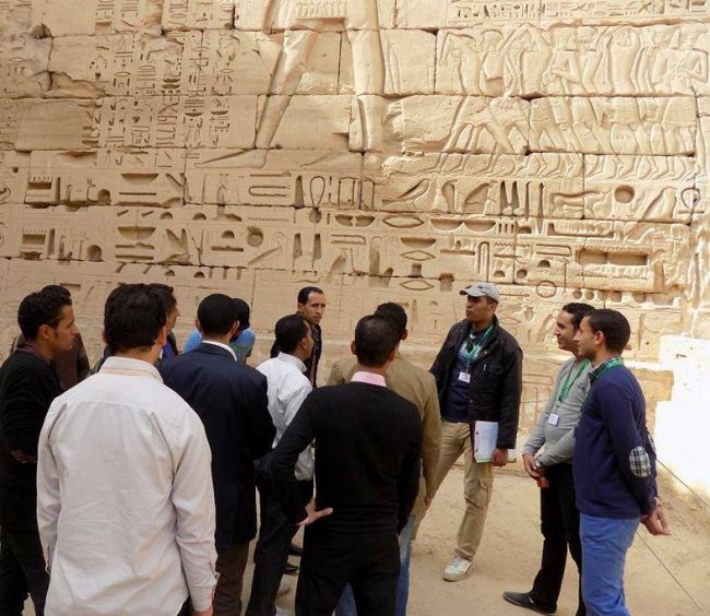 Four colossal ancient Egyptian statues carved into a temple cliff