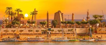 Luxor skyline with a temple and obelisk at sunset